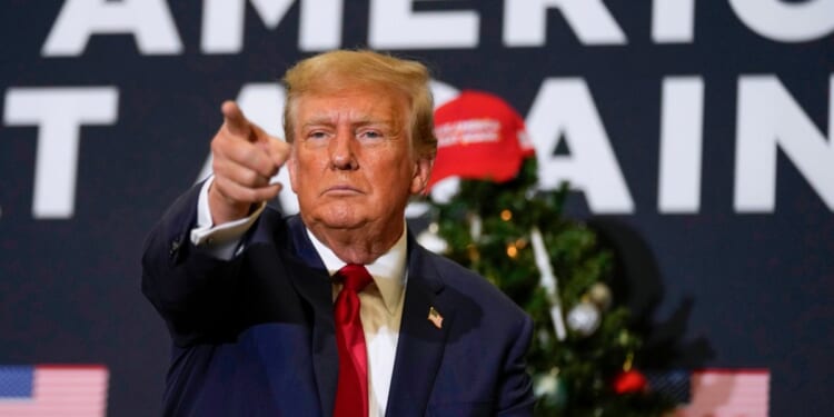 Donald Trump pointing at supporters during an Iowa rally