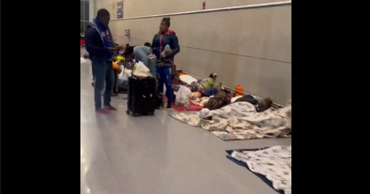 Migrant bedding is spread on the floor of a terminal at Boston's Logan International Airport.