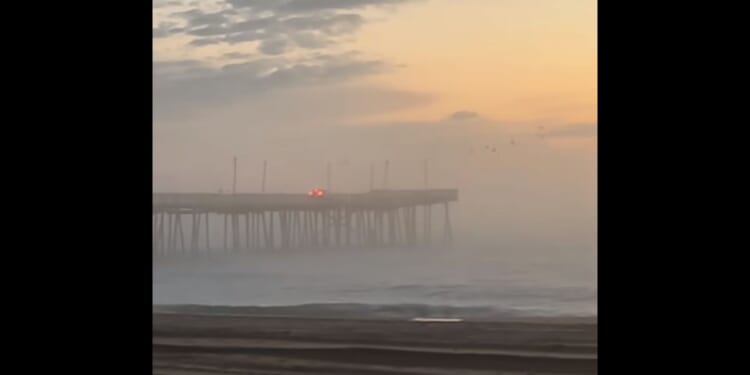 An SUV is driven off the end of the pier in Virginia Beach, Virginia, on Saturday morning.