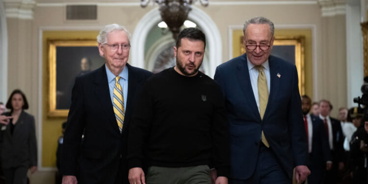 Walking with Senate Minority Leader Mitch McConnell (R-KY), left, and Senate Majority Leader Chuck Schumer (D-NY), right, Ukrainian President Volodymyr Zelenskyy arrives at the U.S. Capitol to meet with Congressional leadership on Dec. 12, in Washington, D.C.