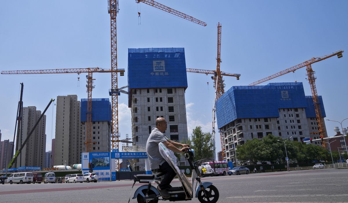 China pledges more help for its ailing property market, as IMF forecasts economy will slow