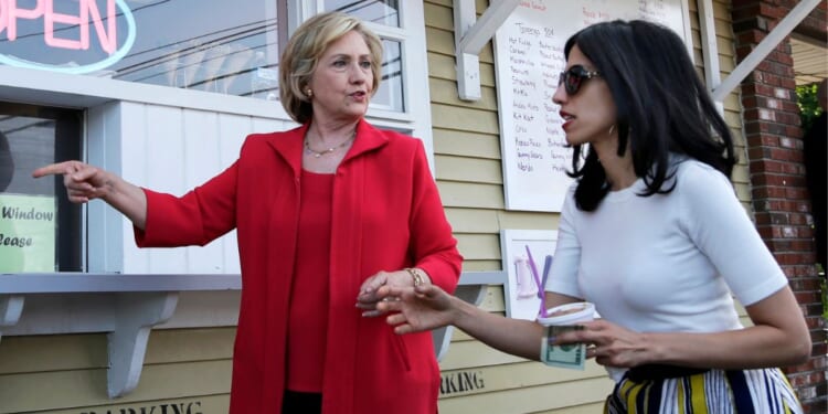 Hillary Clinton and her personal aide Huma Abedin approach a window to buy ice cream in New Hampshire during the 2016 primary