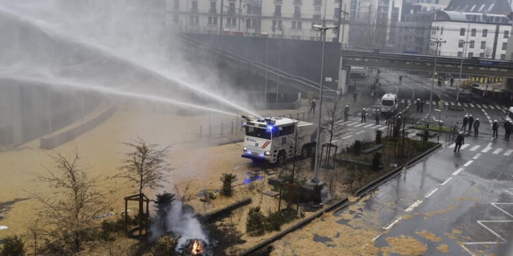 Angry farmers clash with police near the European Union's headquarters in a fresh show of force