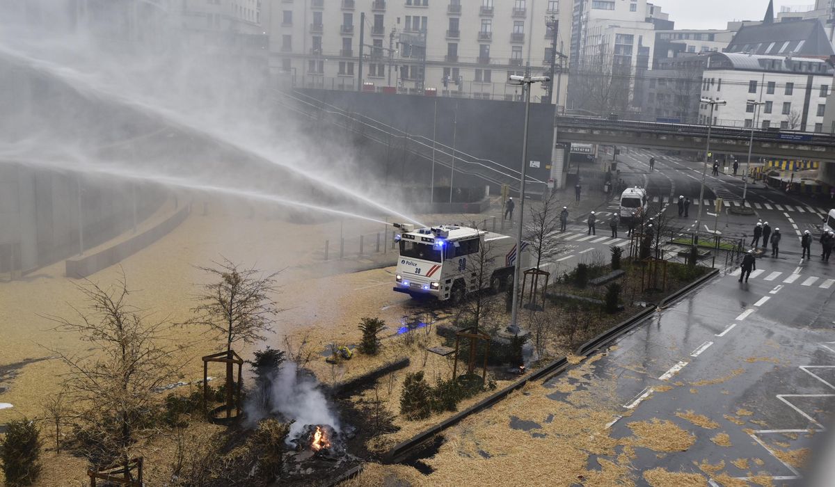 Angry farmers clash with police near the European Union's headquarters in a fresh show of force