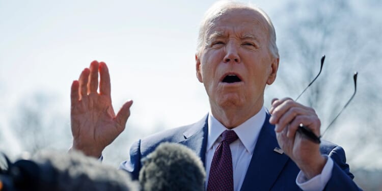 President Joe Biden talks to reporters as he departs the White House in Washington on Tuesday.