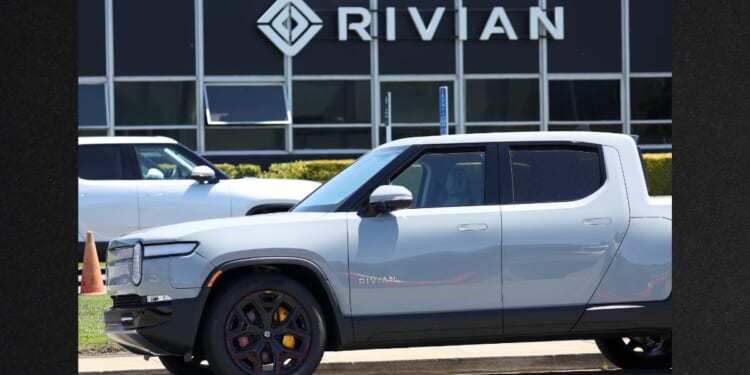 A Rivian electric truck sits parked in front of a Rivian service center on Aug. 8, 2023, in South San Francisco, California.