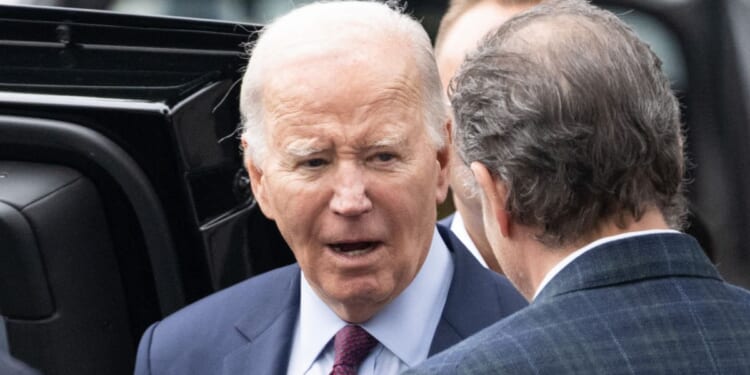 President Joe Biden talks to son Hunter Biden outside The Ivy restaurant in Los Angeles, California, on Sunday.