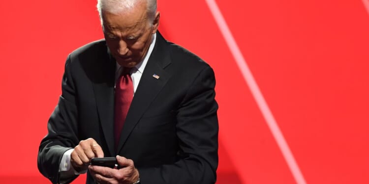 Then-presidential candidate Joe Biden looks at his phone after a debate at Otterbein University in Westerville, Ohio, on Oct. 15, 2019.