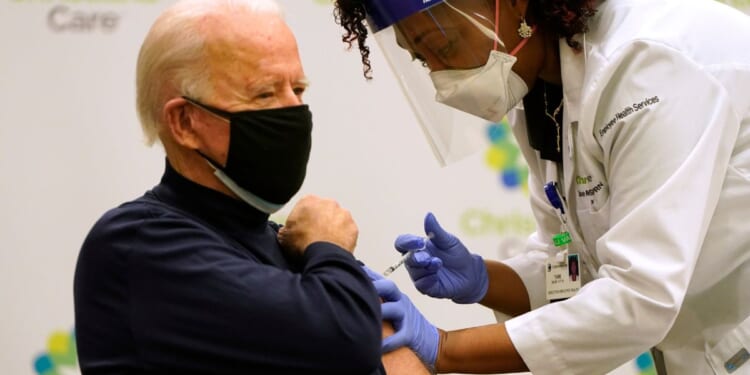 Joe Biden receives a COVID-19 vaccination from nurse practitioner Tabe Mase at ChristianaCare Christiana Hospital in Newark, Delaware, on Dec. 21, 2020.