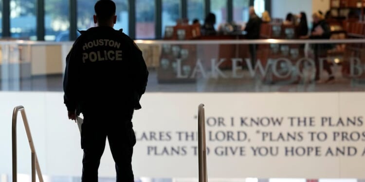 A police officer stands at the top of the steps inside the Lakewood Church in Houston, Texas, on Feb. 18.