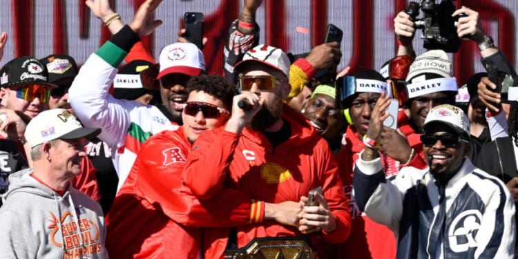 Kansas City Chiefs tight end Travis Kelce, center, speaks to fans during the Super Bowl LVIII celebration in Kansas City, Missouri, on Wednesday.