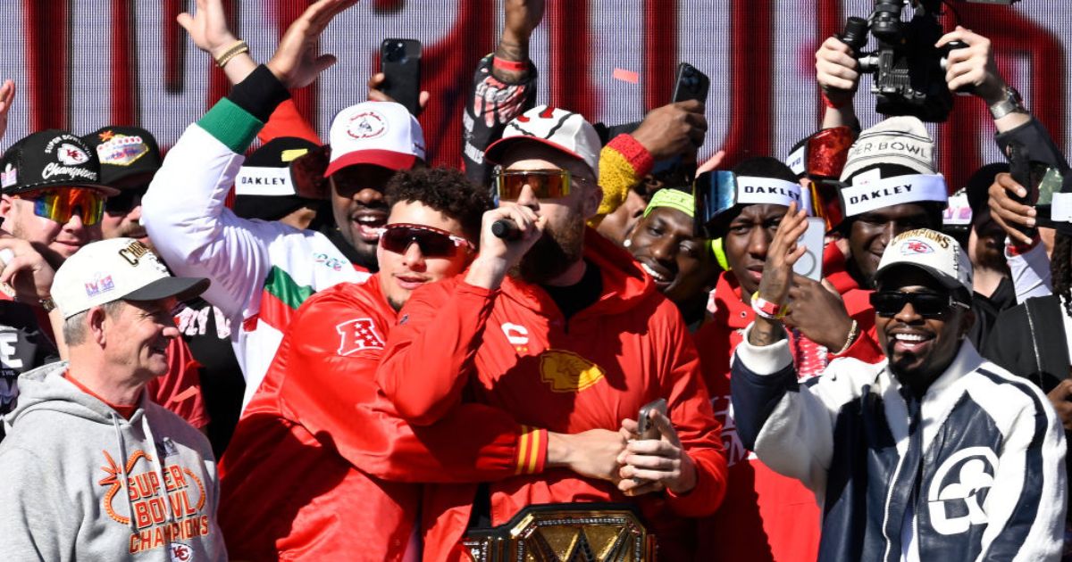 Kansas City Chiefs tight end Travis Kelce, center, speaks to fans during the Super Bowl LVIII celebration in Kansas City, Missouri, on Wednesday.