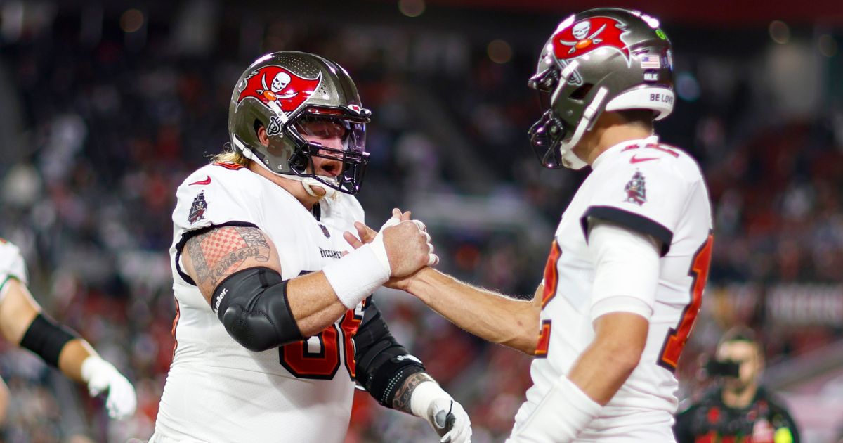 Ryan Jensen, left, and Tom Brady shake hands prior to the Tampa Bay Buccaneers' wild-card playoff game against the Dallas Cowboys at Raymond James Stadium in Tampa, Florida, on Jan. 16, 2023.