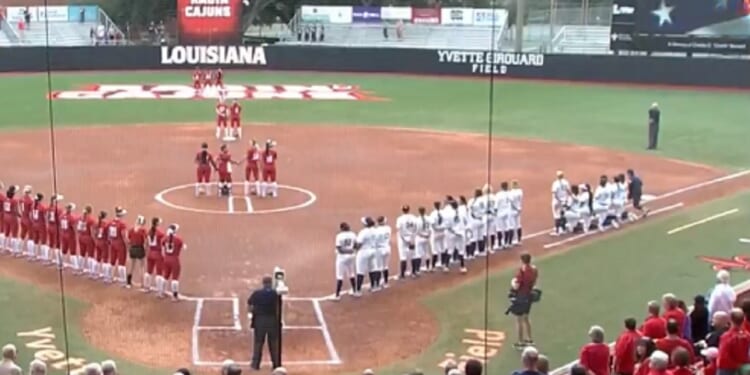 Softball players from the University of California, Berkeley, kneel during the national anthem prior to a Feb. 9 game at the University of Louisiana, Lafayette.