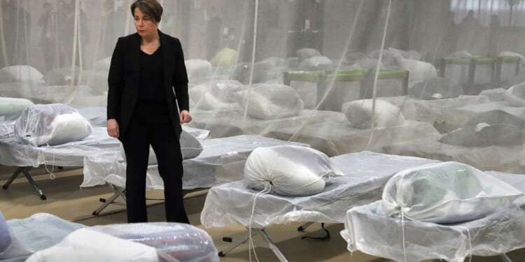 Massachusetts Gov. Maura Healey inspected cots set up on the gym floor in the Melnea A. Cass Recreational Complex, Wednesday, in the Roxbury neighborhood of Boston. The facility will house over 300 migrants.