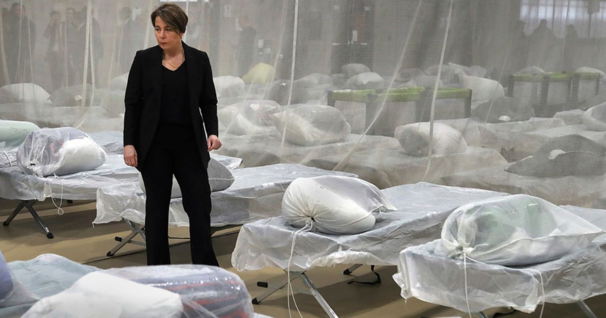 Massachusetts Gov. Maura Healey inspected cots set up on the gym floor in the Melnea A. Cass Recreational Complex, Wednesday, in the Roxbury neighborhood of Boston. The facility will house over 300 migrants.