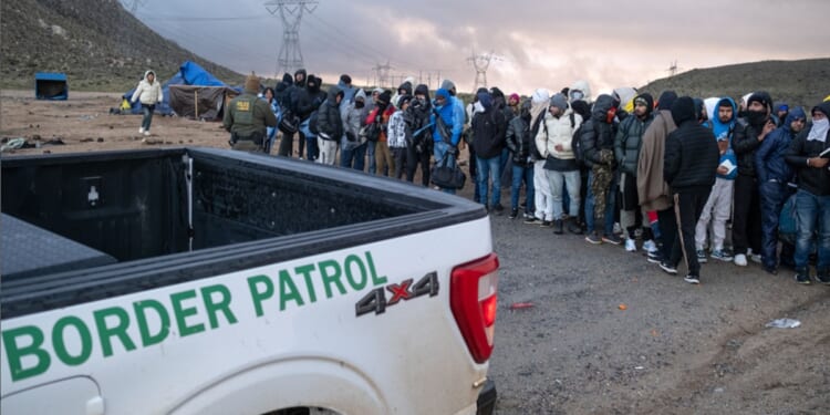 Illegal immigrants wait in line to be processed Jan. 2 by the Border Patrol at a makeshift camp near the U.S.-Mexico border in San Diego County, California.