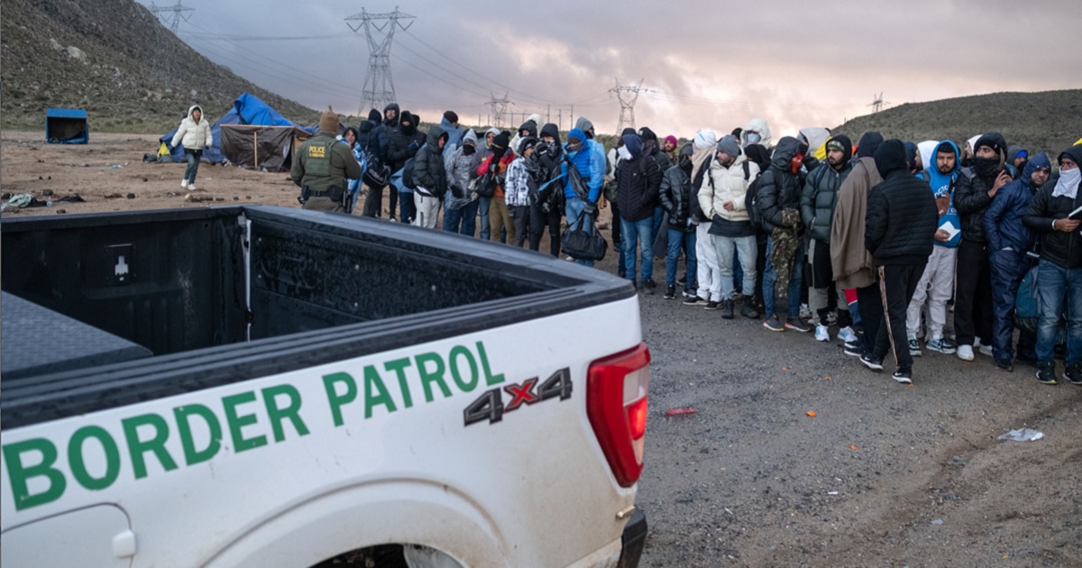 Illegal immigrants wait in line to be processed Jan. 2 by the Border Patrol at a makeshift camp near the U.S.-Mexico border in San Diego County, California.