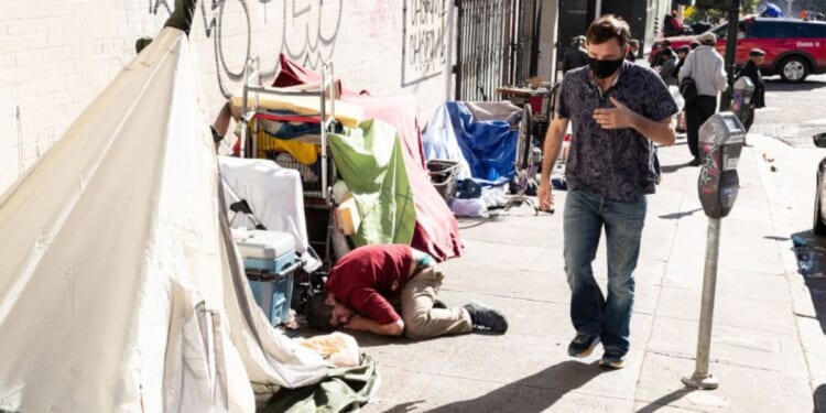 People and their belongings are seen on Jones Street in San Francisco, Nov. 13, 2023.