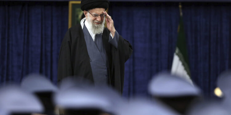 Iranian Supreme Leader Ayatollah Ali Khamenei salutes during a meeting with military staff in Tehran on Monday.