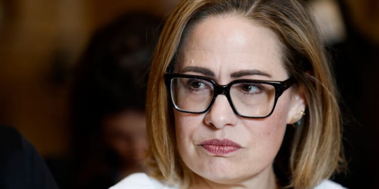 Sen. Kyrsten Sinema speaks to reporters in the U.S. Capitol Building on Washing, D.C., on Dec. 20.