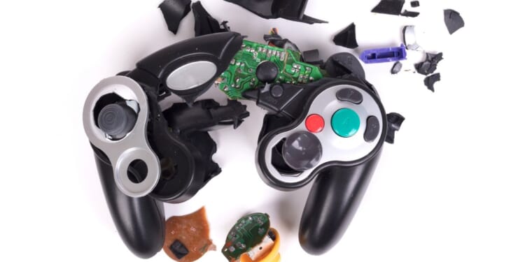 A broken video game controller displayed in front of a white background.