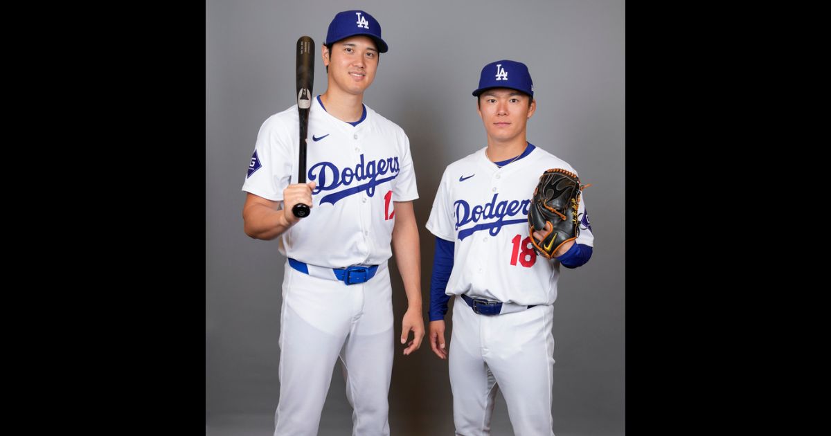 Los Angeles Dodgers designated hitter Shohei Ohtani, left, and starting pitcher Yoshinobu Yamamoto pose for a photo during a spring training baseball photo day, Wednesday, in Phoenix.