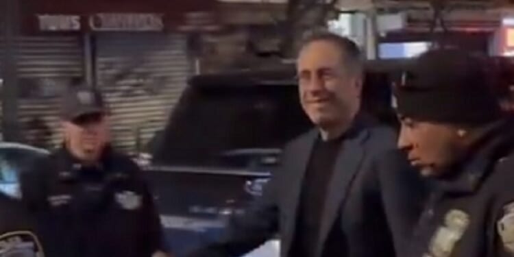 Comedian Jerry Seinfeld is unfazed as he is confronted by protesters in New York City on Saturday.