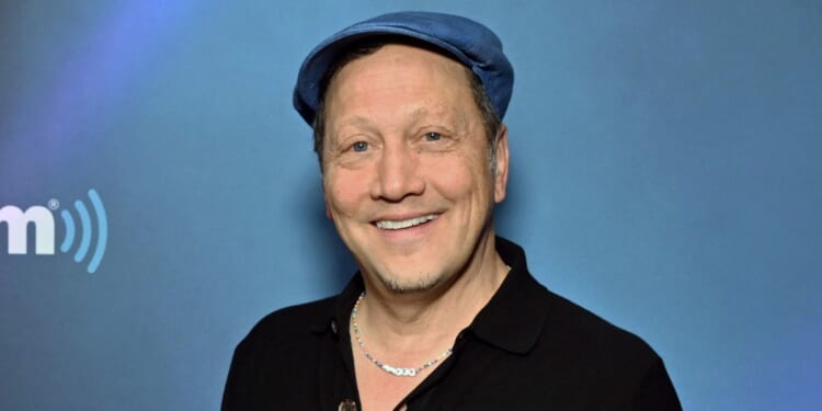 Comedian Rob Schneider, seen in a June 2023 photo, told an interviewer that Jesus "grabbed" him and "hugged" him.