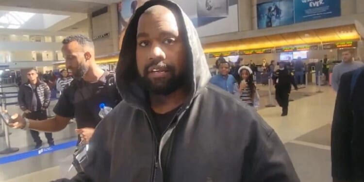 Rapper Kanye West is questioned by journalists Monday at Los Angeles International Airport.