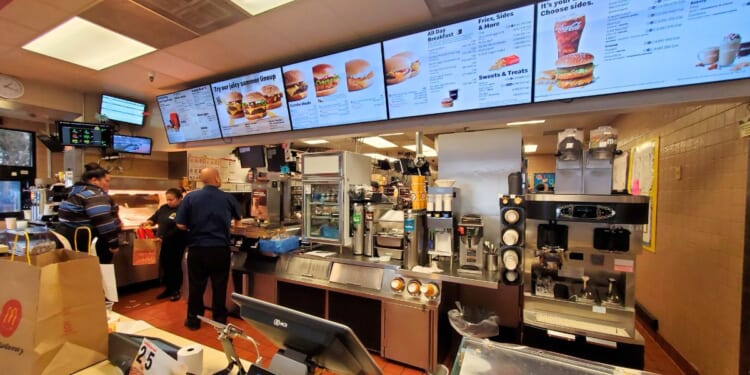 The counter area, kitchen and menus are visible in a wide-angle view of the interior of a McDonald's restaurant in San Ramon, California, on Jan. 21, 2020.