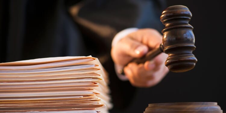 A judge is shown on the bench with a gavel.