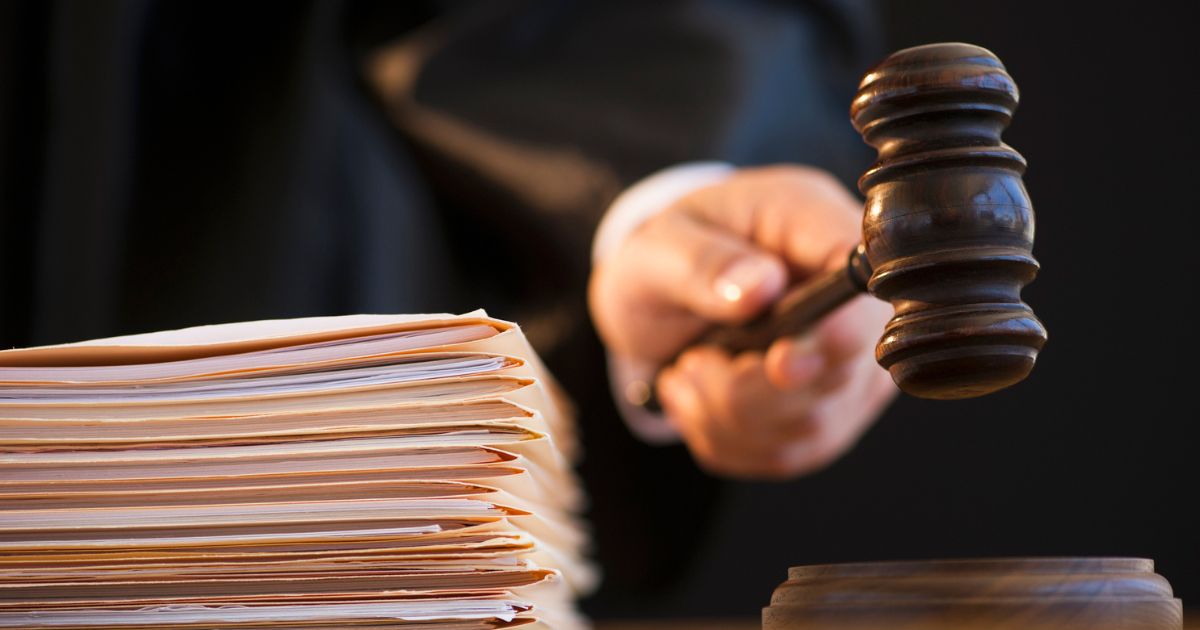 A judge is shown on the bench with a gavel.