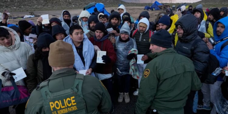 U.S. Border Patrol agents on Friday spoke with migrants seeking asylum, mainly from Colombia, China and Ecuador, after crossing the border between Mexico and the U.S. near Jacumba, California.