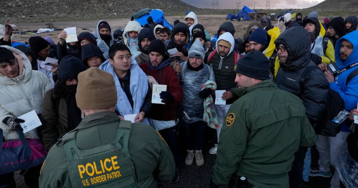 U.S. Border Patrol agents on Friday spoke with migrants seeking asylum, mainly from Colombia, China and Ecuador, after crossing the border between Mexico and the U.S. near Jacumba, California.