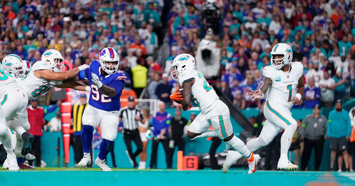 Tua Tagovailoa of the Miami Dolphins hands off to De'Von Achane during a game against the Buffalo Bills at Hard Rock Stadium in Miami Gardens, Florida, on Jan. 7.