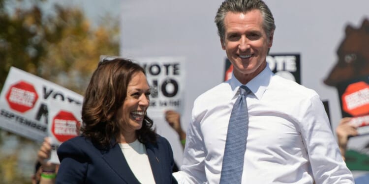 Vice President Kamala Harris, left, and California Gov. Gavin Newsom, right, attend a campaign event against his recall election in San Leandro, California, on Sept. 8, 2021.