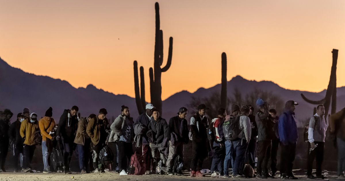 Illegal immigrants line up at a remote U.S. Border Patrol processing center in Lukeville, Arizona, on Dec. 7 after crossing the U.S.-Mexico border.