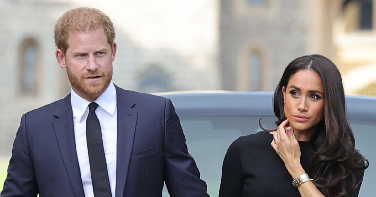 Prince Harry, Duke of Sussex, and Meghan, Duchess of Sussex, arrive on the long walk at Windsor Castle to view flowers and tributes to Queen Elizabeth II on Sept. 10, 2022.