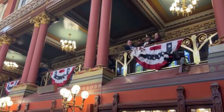 Police officers remove protesters from the Connecticut Capitol in Hartford.