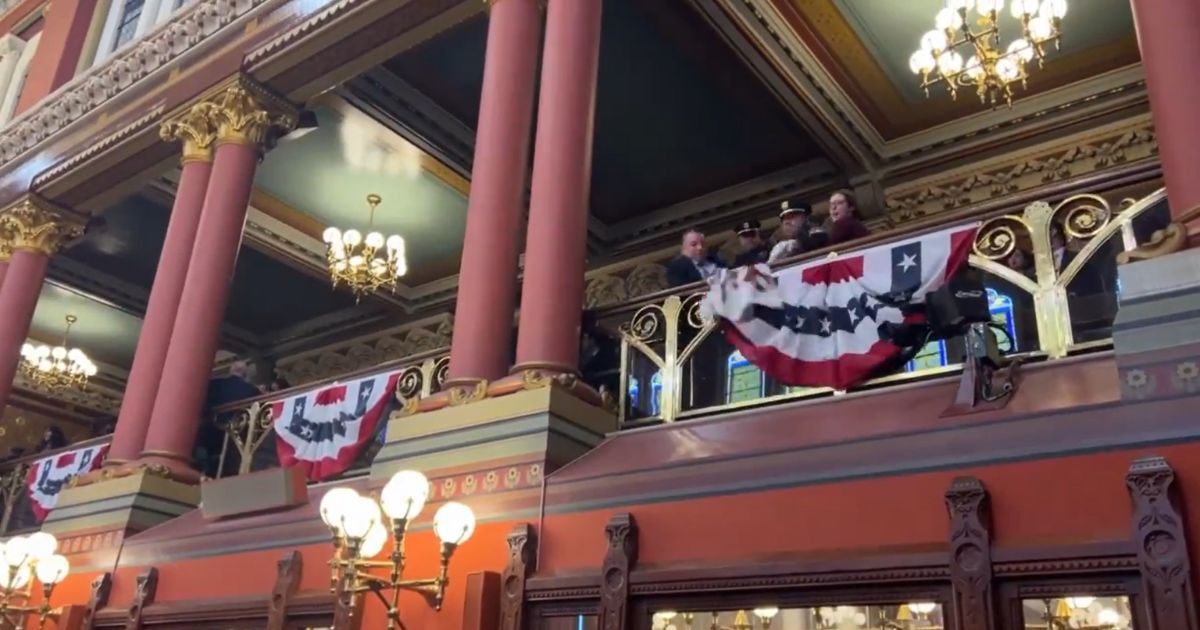 Police officers remove protesters from the Connecticut Capitol in Hartford.