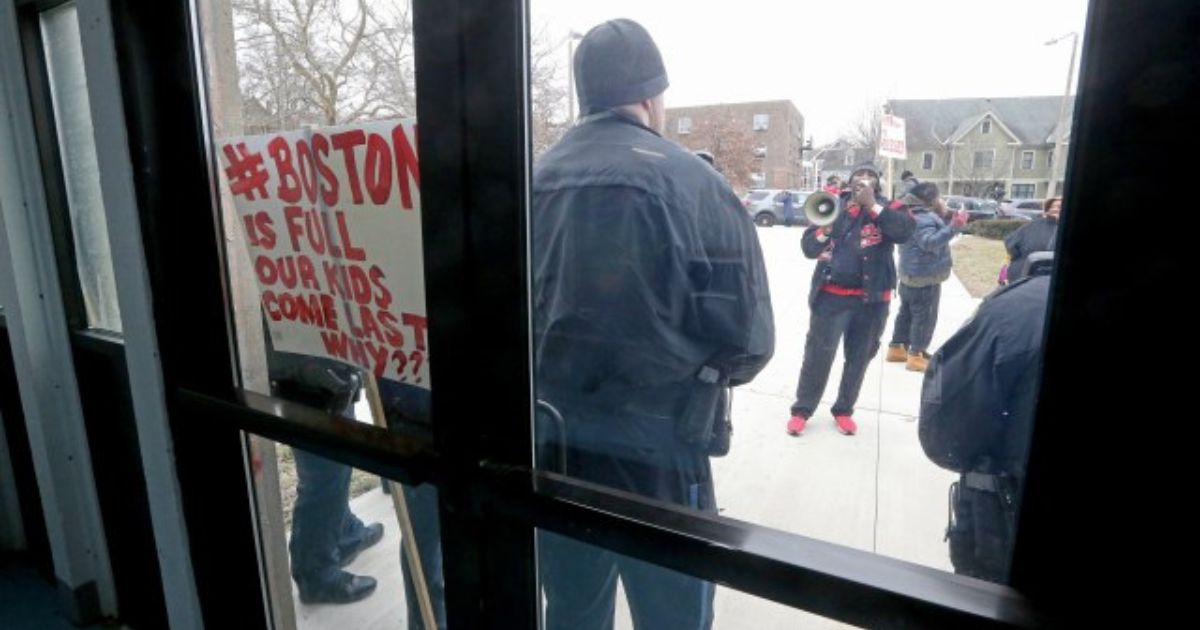 Residents of Roxbury, Massachusetts, protest outside a rec center that's been converted to illegal immigrant housing.