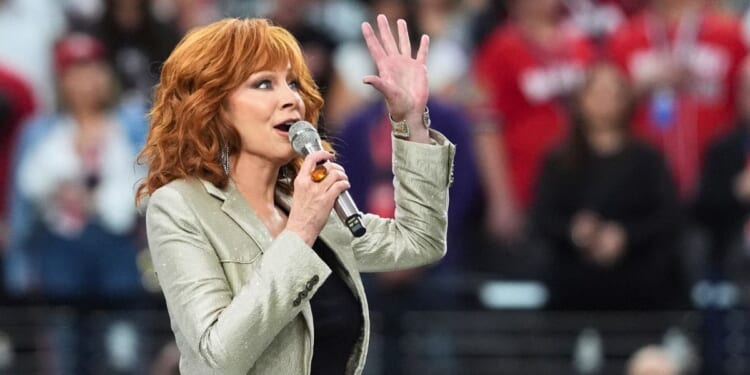 Reba McEntire sings the national anthem ahead of Super Bowl LVIII between the Kansas City Chiefs and the San Francisco 49ers at Allegiant Stadium in Las Vegas on Sunday.