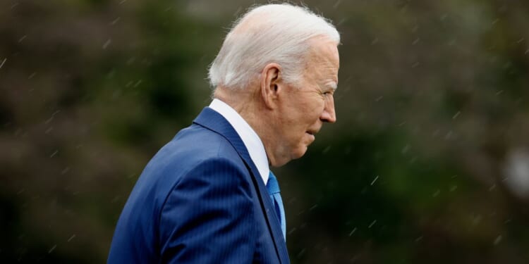 President Joe Biden walks across the South Lawn before boarding Marine One to depart the White House in Washington on Wednesday. "I'm going to Walter Reed to get my physical," Biden told reporters.