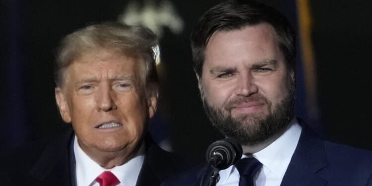 Former President Donald Trump, left, and then-Senate candidate J.D. Vance greet supporters during a rally in Vandalia, Ohio, on Nov. 7, 2022.