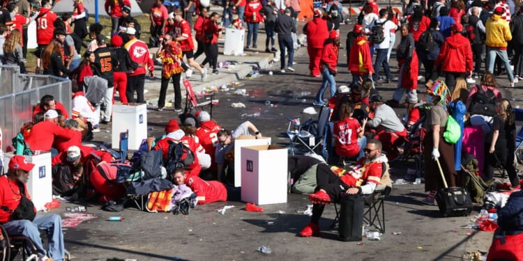 People take cover during a shooting at the Super Bowl LVIII parade for the Kansas City Chiefs in Kansas City, Missouri, on Wednesday.