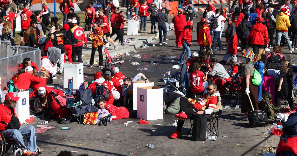 People take cover during a shooting at the Super Bowl LVIII parade for the Kansas City Chiefs in Kansas City, Missouri, on Wednesday.