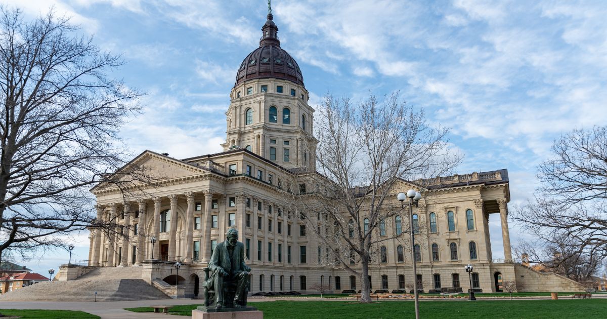 A stock photo shows the Kansas state Capitol, with a statue of Abraham Lincoln in the foreground, in Topeka on March 27, 2021.