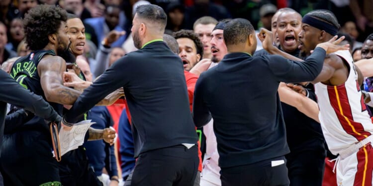 New Orleans Pelicans forward Naji Marshall, left, and Miami Heat forward Jimmy Butler, right, are separated during a scuffle in the second half of an NBA basketball game in New Orleans on Friday.