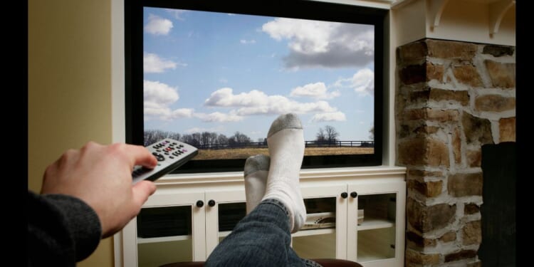 A person kicking back and watching some television.